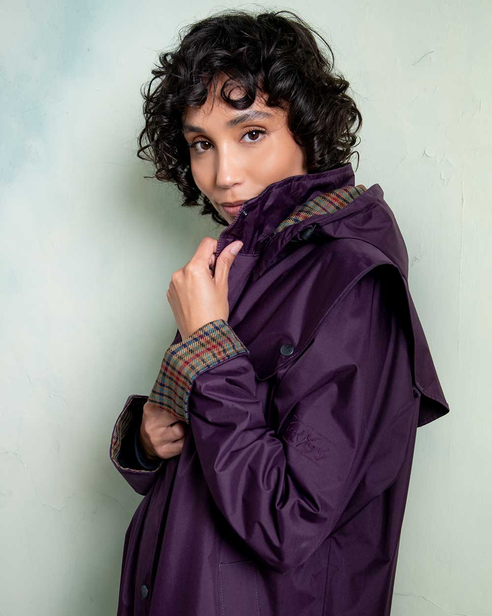 Blackberry coloured Jack Murphy Malvern Ladies Waterproof Bush Coat on wall background