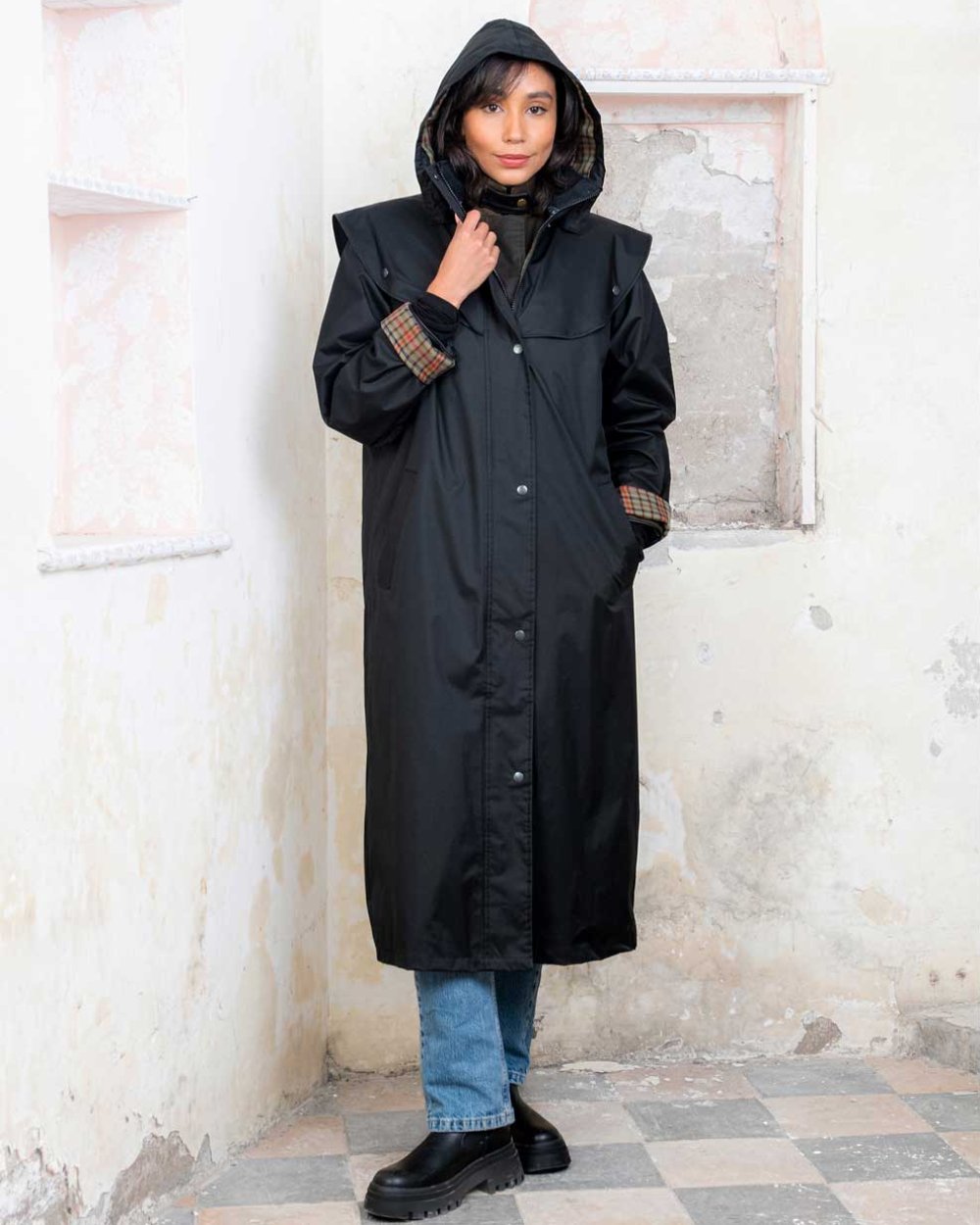 Black coloured Jack Murphy Malvern Ladies Waterproof Bush Coat on wall background