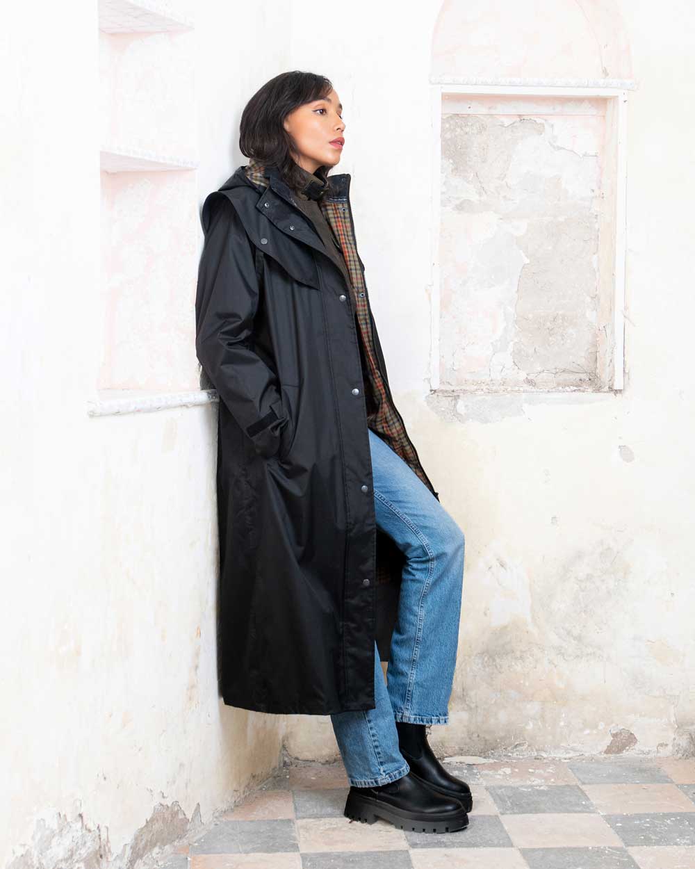 Black coloured Jack Murphy Malvern Ladies Waterproof Bush Coat on wall background