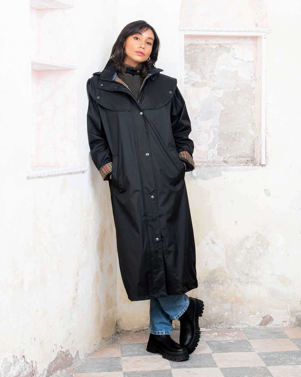 Black coloured Jack Murphy Malvern Ladies Waterproof Bush Coat on wall background