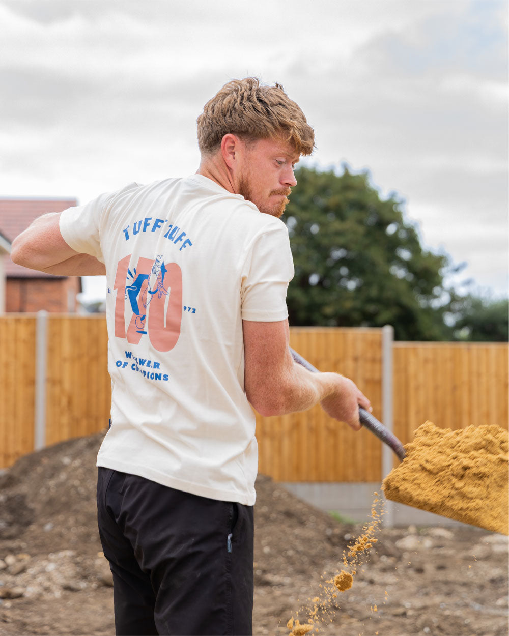 Male model wearing White coloured TuffStuff Icon T-Shirt shovelling sand