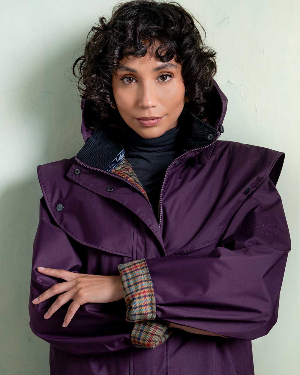Blackberry coloured Jack Murphy Malvern Ladies Waterproof Bush Coat on wall background