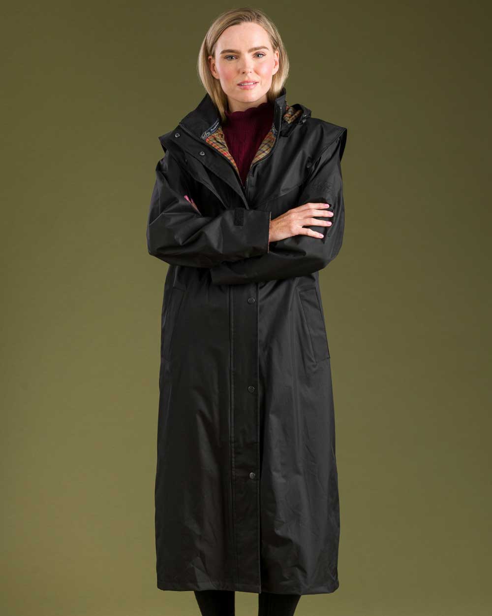 Black coloured Jack Murphy Malvern Ladies Waterproof Bush Coat on wall background