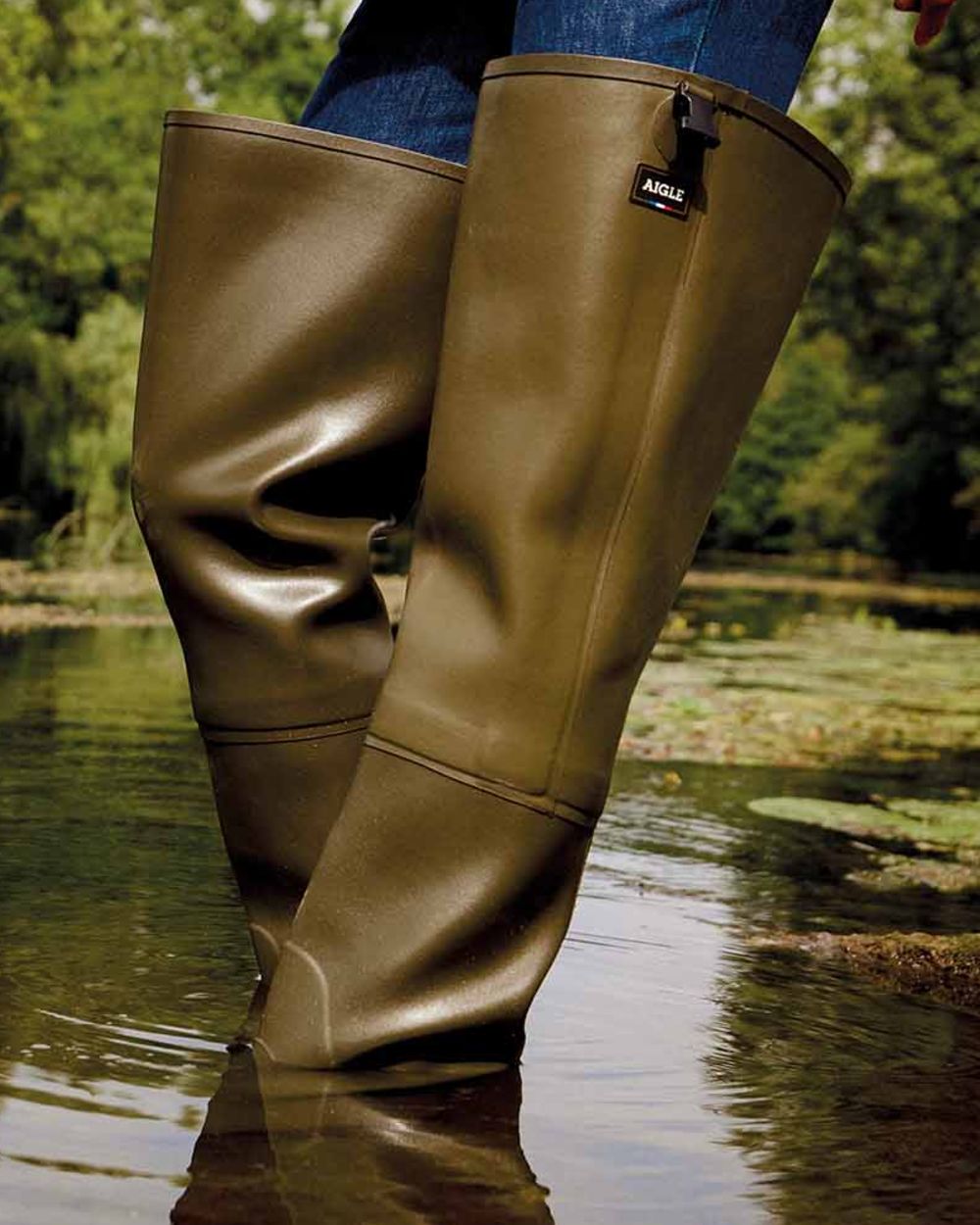 Khaki coloured Aigle Mens Truite Versatile Fishing Waders on lake background