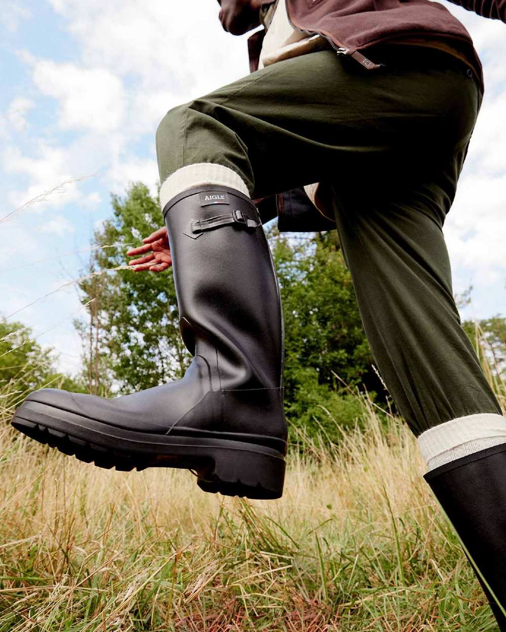 Noir coloured Aigle Womens Cessac Gardening Wellingtons on forest background