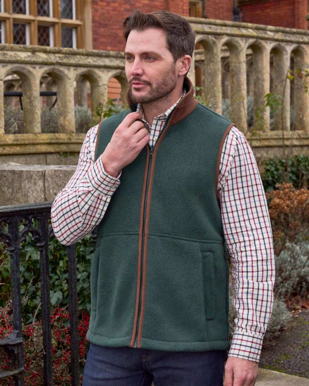 Evergreen coloured Alan Paine Aylsham Fleece Gilet on outdoor background