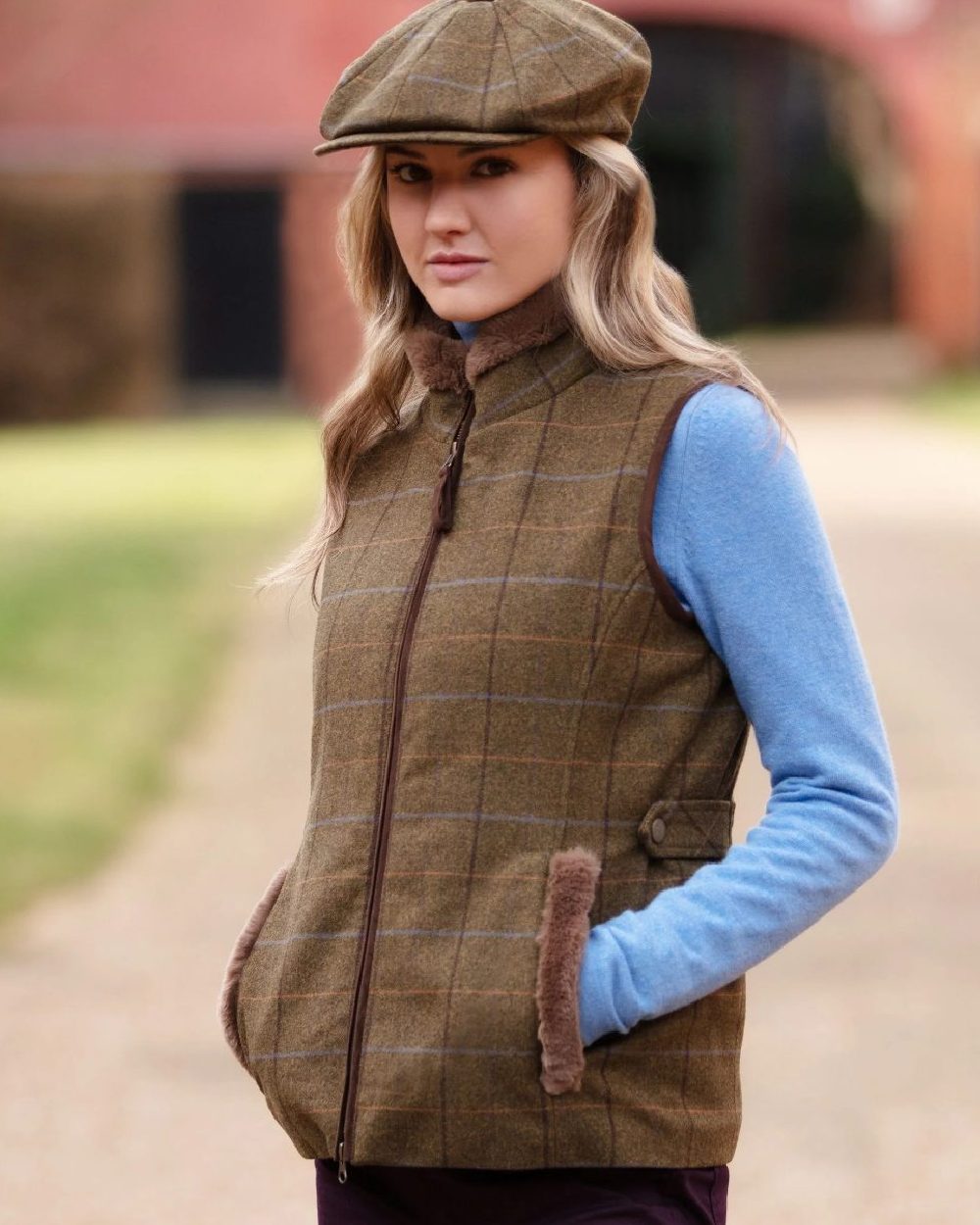 Hazel Coloured Alan Paine Combrook Tweed Ladies Gilet on blurry background