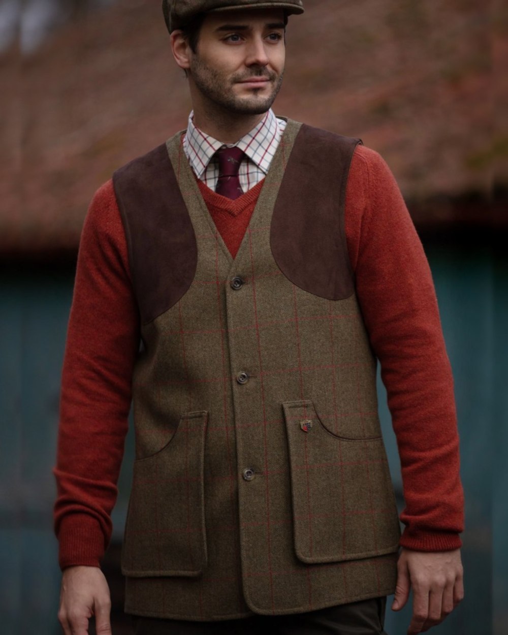 Sage coloured Alan Paine Combrook Tweed Shooting Waistcoat on blurry background