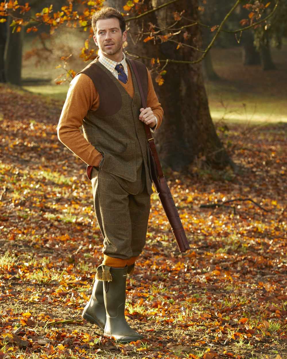 Teak coloured Alan Paine Combrook Tweed Shooting Waistcoat on forest background