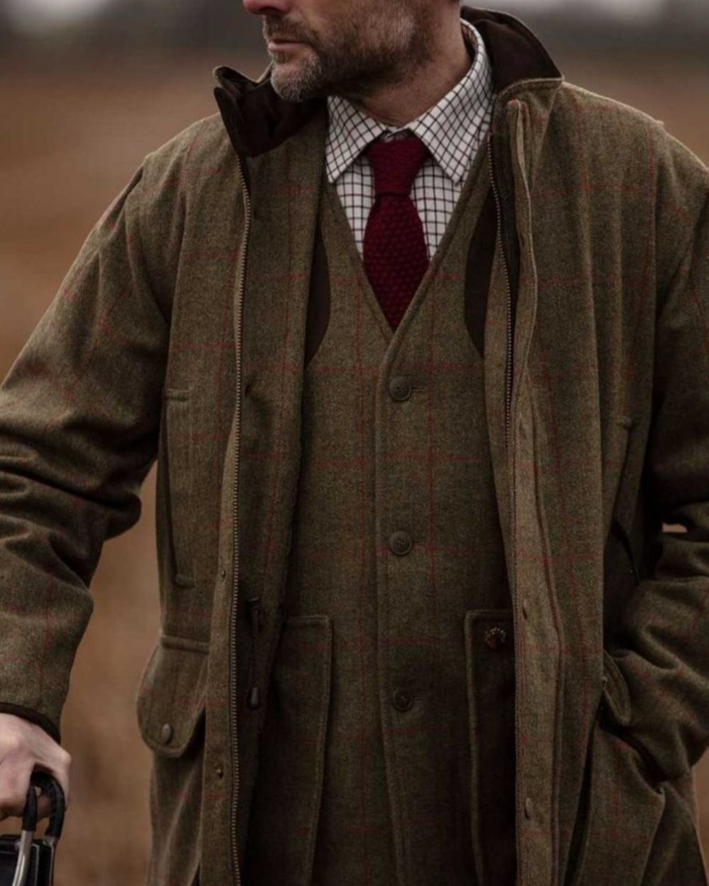 Sage coloured Alan Paine Mens Combrook Field Coat on blurry background