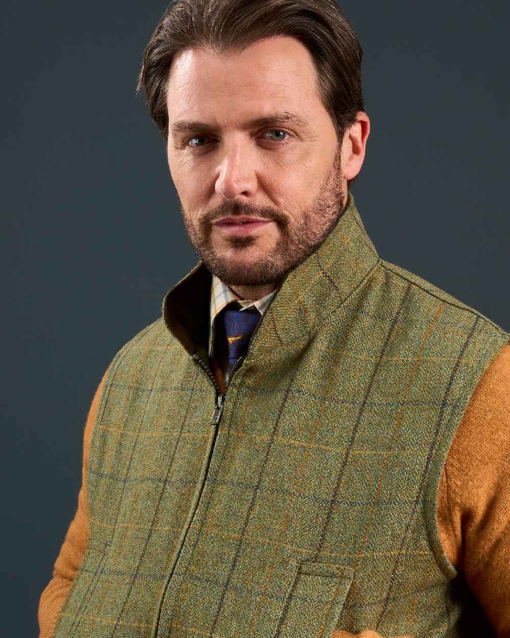 Dark Moss Coloured Alan Paine Rutland Tweed Waistcoat on indoor background