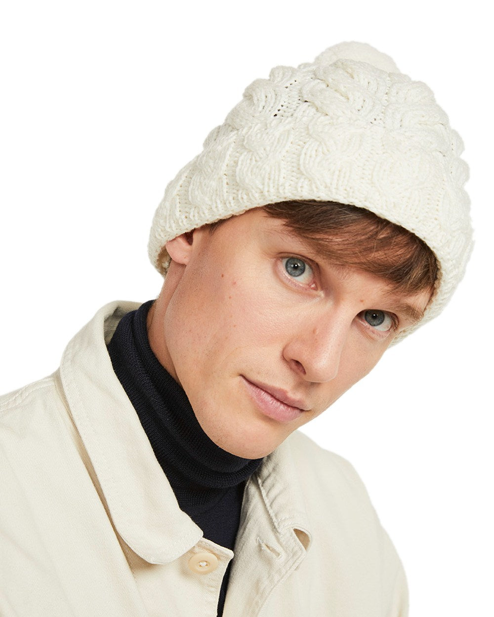 Cream Coloured Aran Chunky Knit Bobble Hat on white background