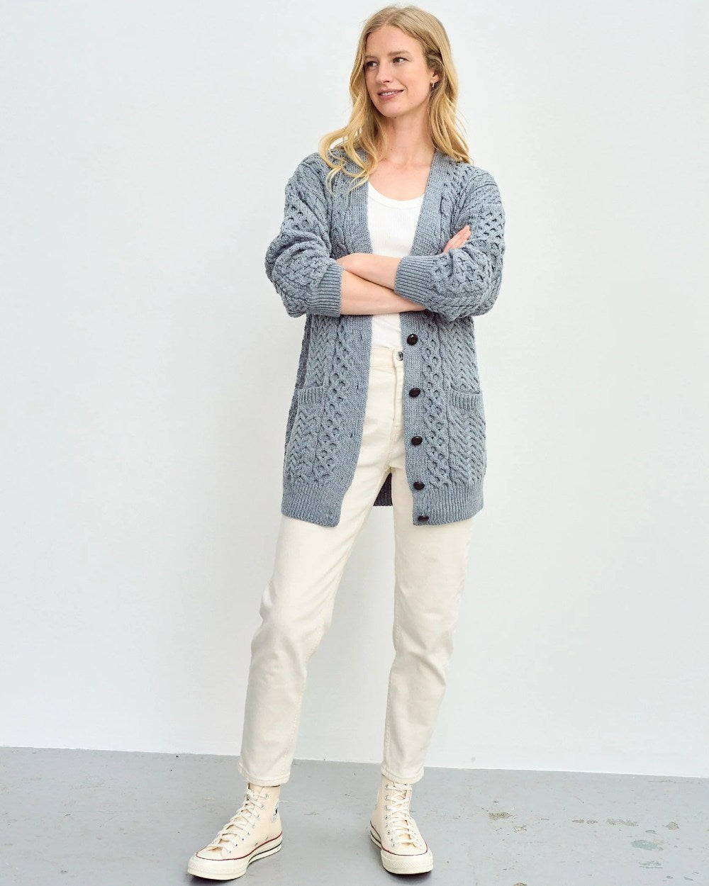 Blue Grey Coloured Aran Delphi Boyfriend Cardigan on grey wall background