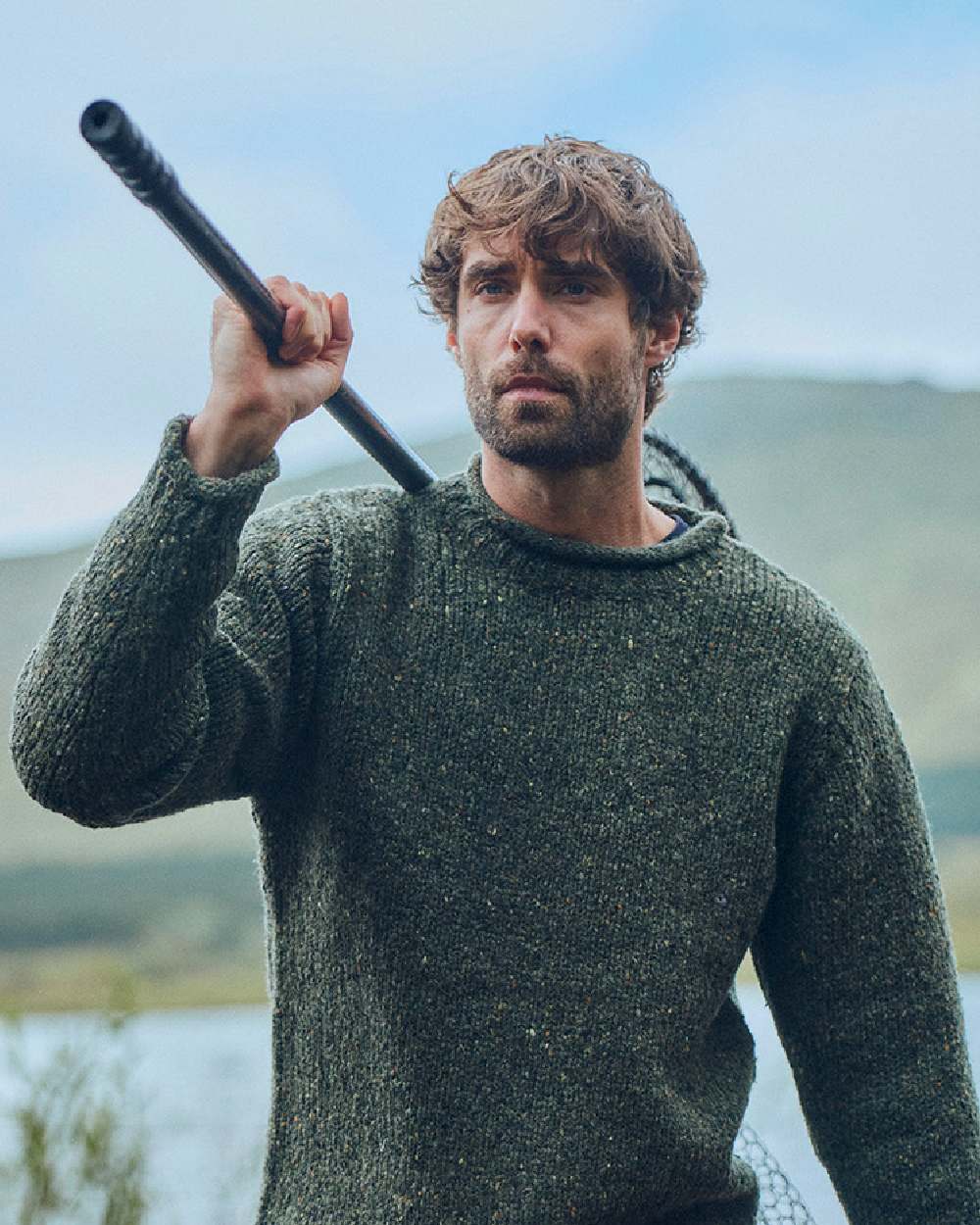 Green Coloured Aran Donegal Wool Crew Neck Sweater on blurry background