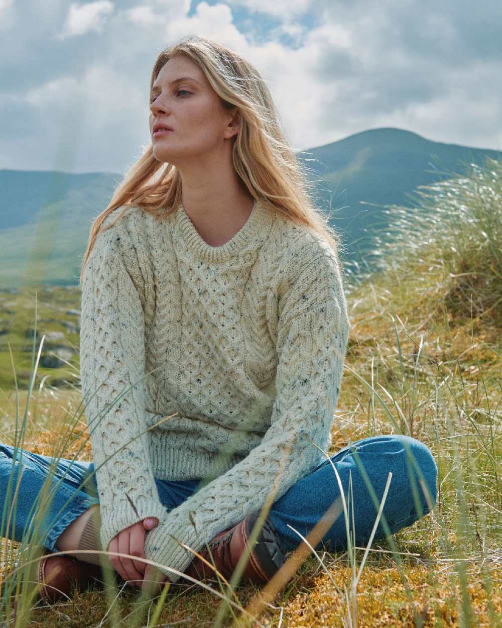 Flecked Cream coloured Aran Inishbofin Traditional Sweater on hillside background