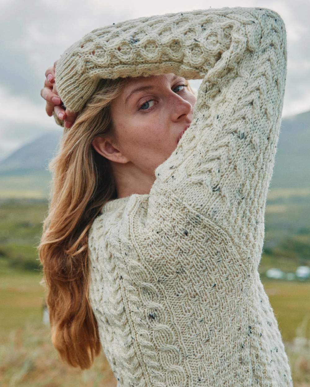 Flecked Cream coloured Aran Inishbofin Traditional Sweater on hillside background