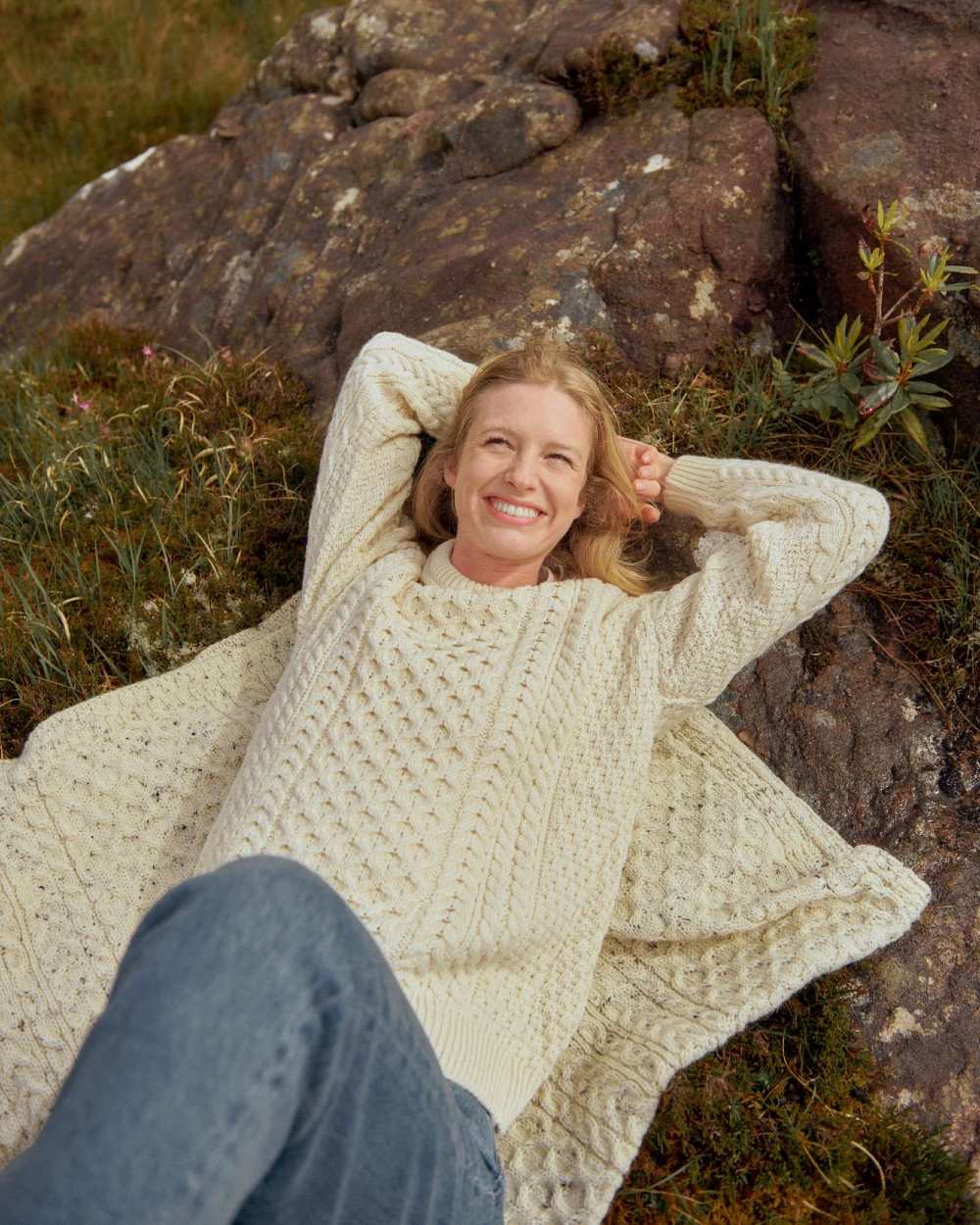 Cream Coloured Aran Inisheer Traditional Sweater on stone background