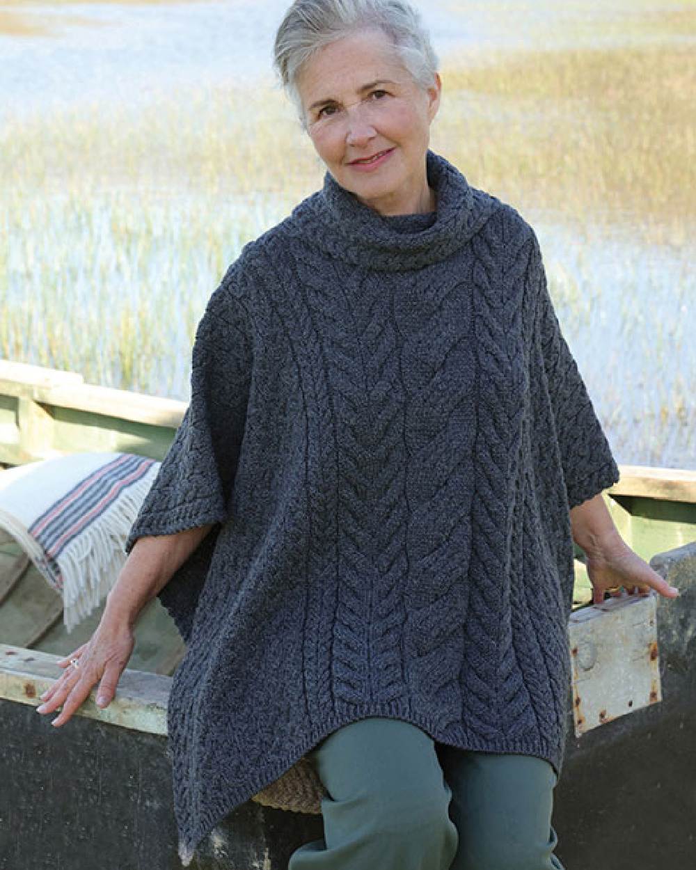 Grey Coloured Aran Merino Wool Cowl Neck Poncho on lake background