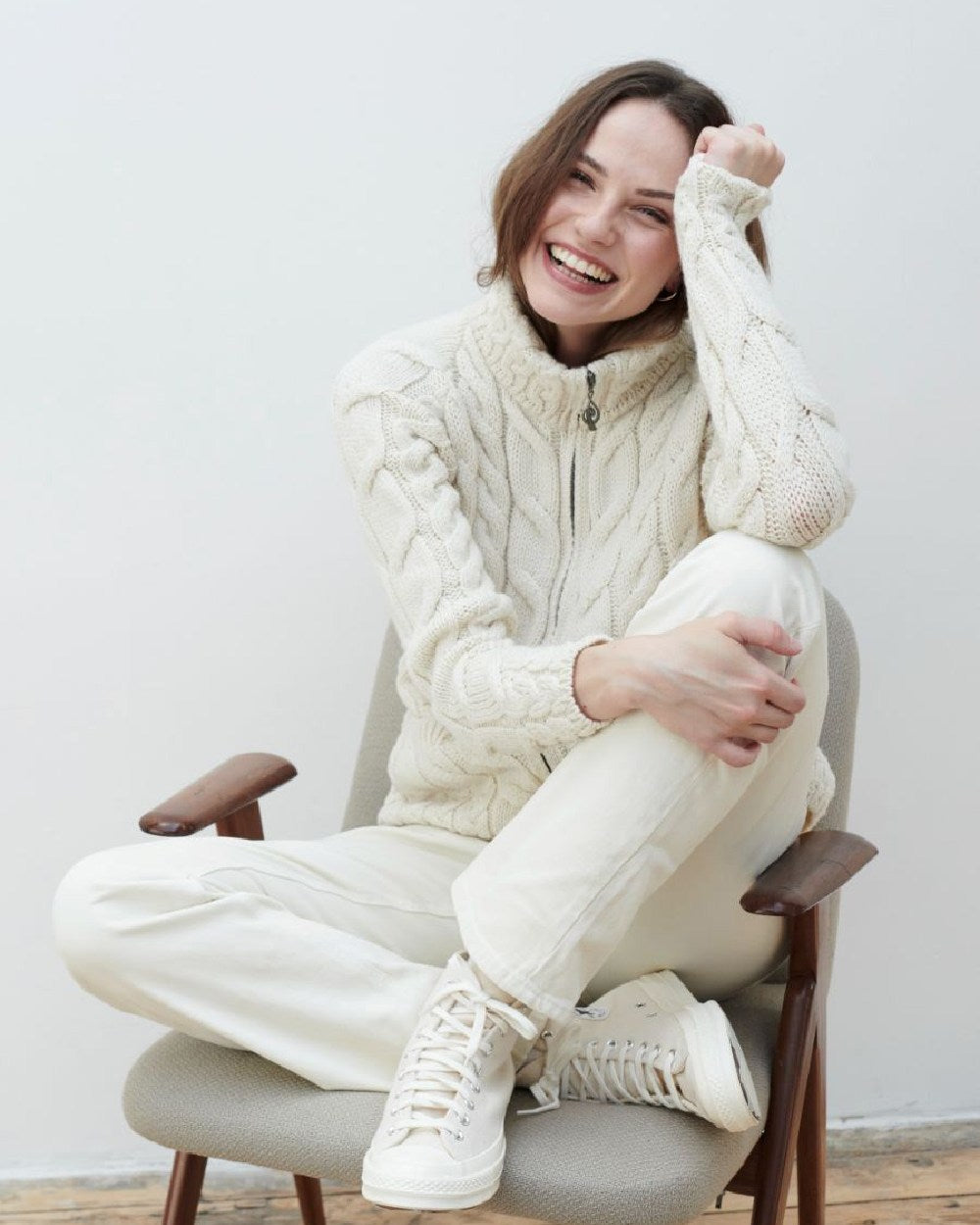 Cream Coloured Aran Merino Wool Full Zip Cardigan on grey wall background