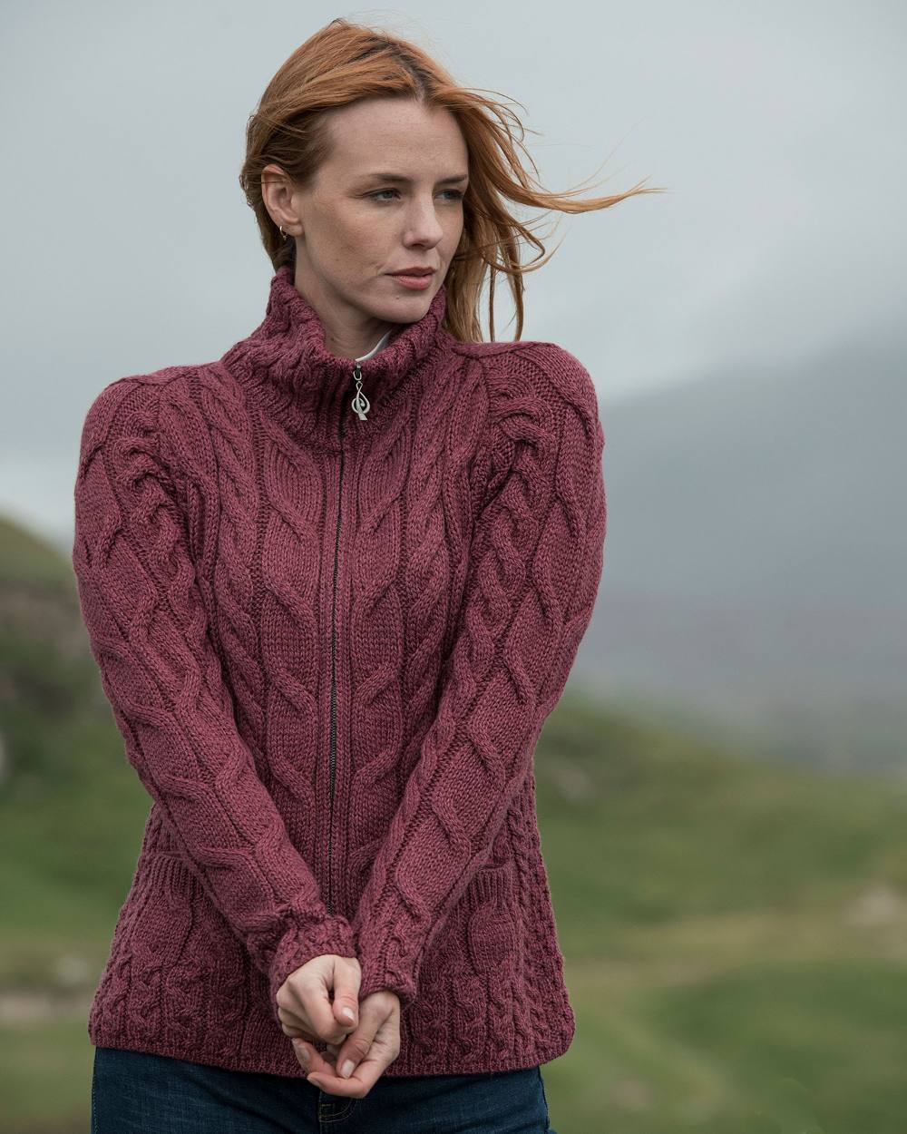 Jam Coloured Aran Merino Wool Full Zip Cardigan on blurry background