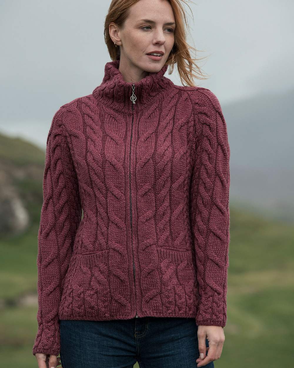 Jam Coloured Aran Merino Wool Full Zip Cardigan on blurry background
