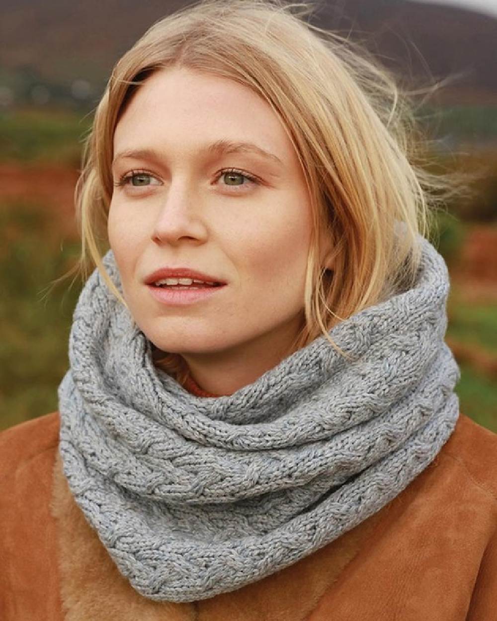 Grey coloured Aran Merino Wool Snood on blurry background