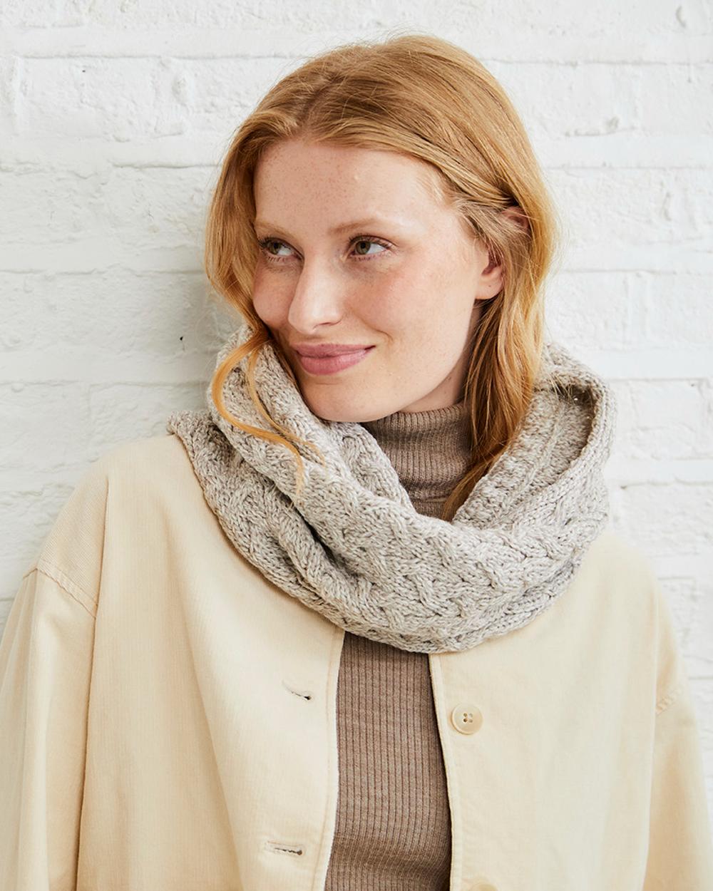 Oat coloured Aran Merino Wool Snood on grey wall background