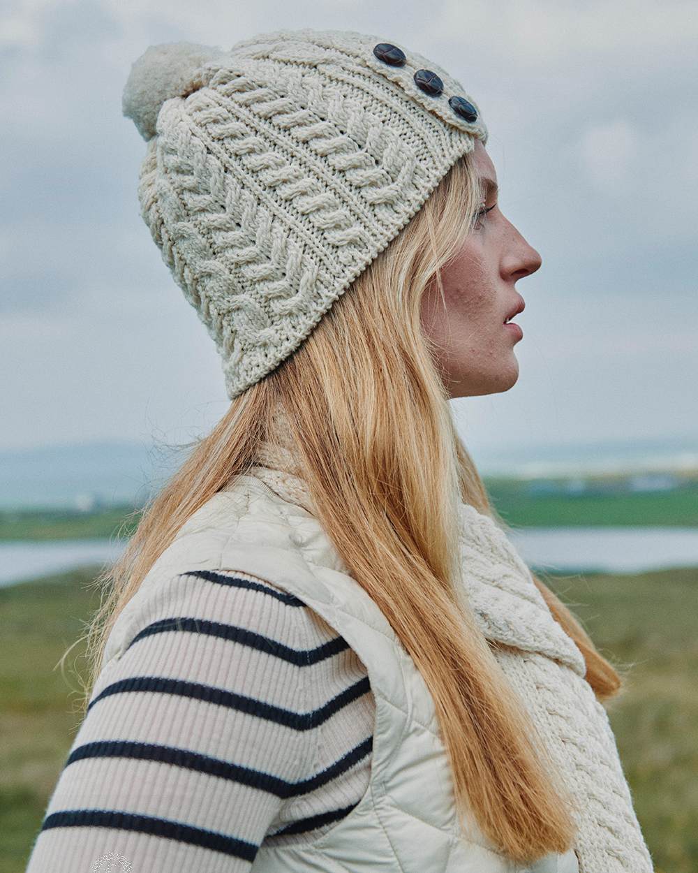 Cream Coloured Aran Womens Cong Hat With Pom Pom on outdoor background