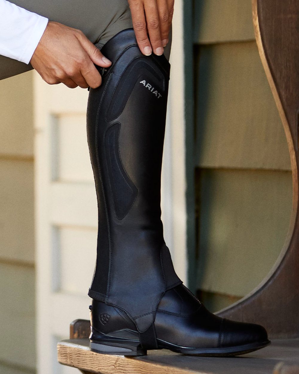 Black coloured Ariat Heritage Contour Half Chap on wall background