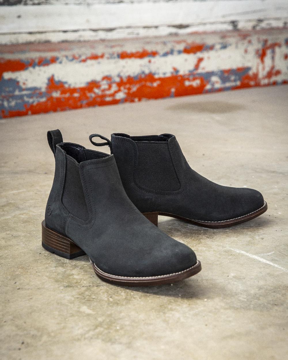 Den Black Coloured Ariat Mens Booker Ultra Round Toe Western Boot on floor background