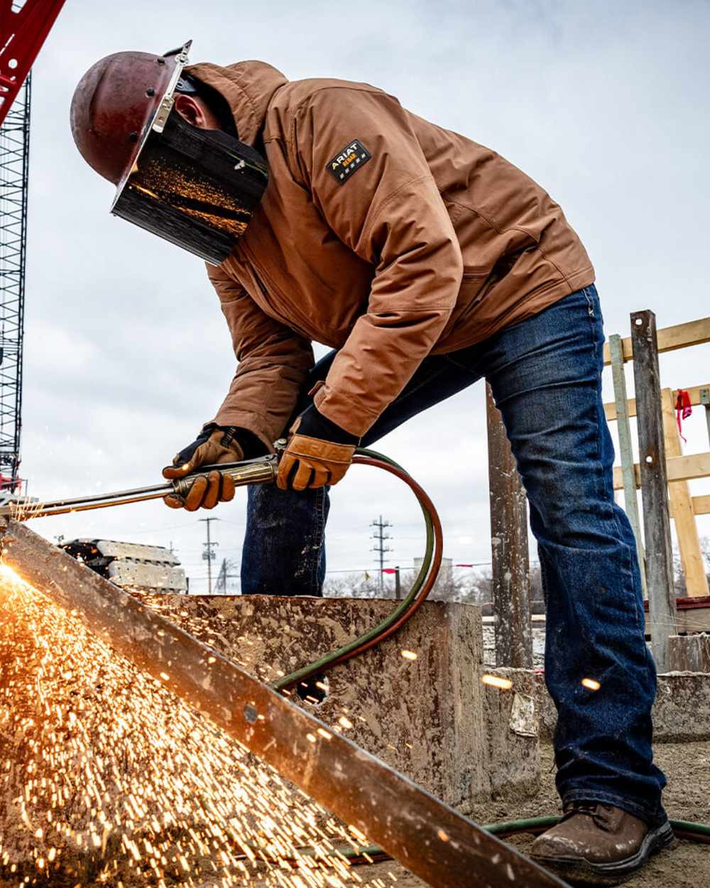 Bodie coloured Ariat Mens Rebar M7 Slim DuraStretch Edge Stackable Straight Jeans on outdoor background