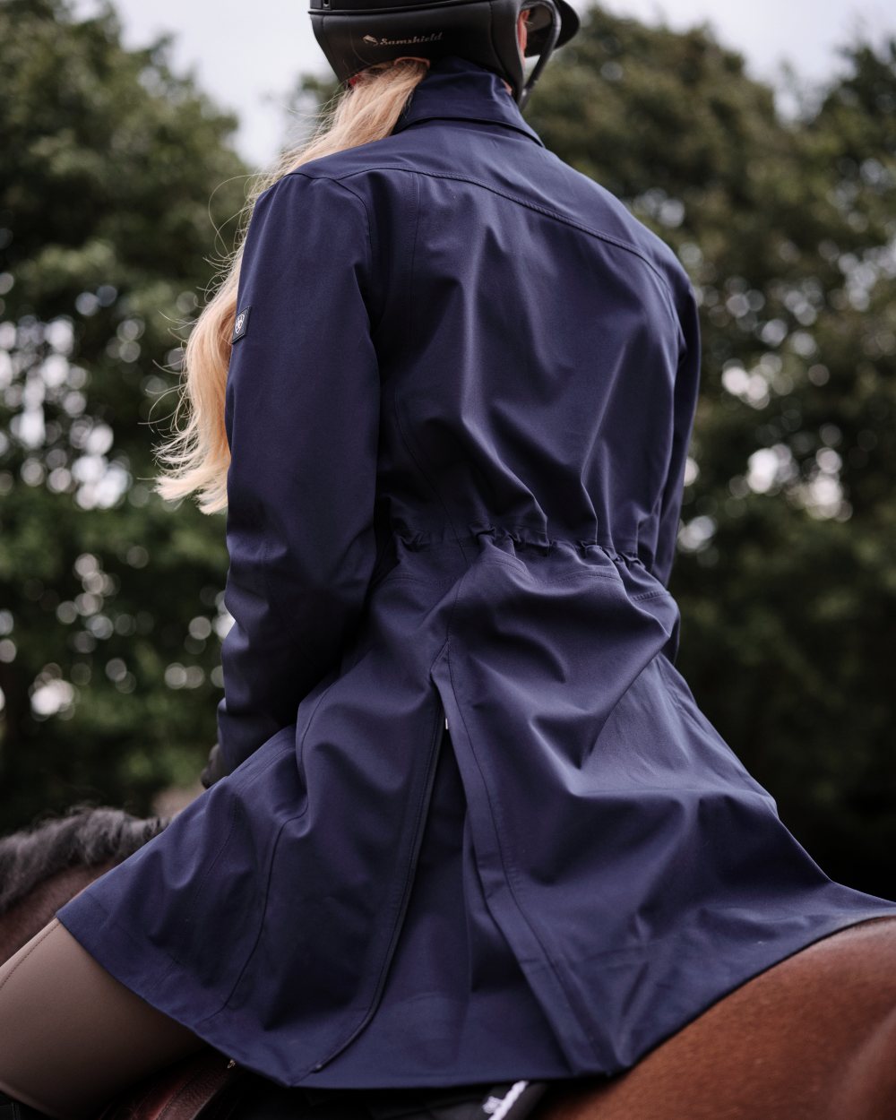 Navy Eclipse Coloured Ariat Womens Coastal Long Waterproof Parka on outdoor background