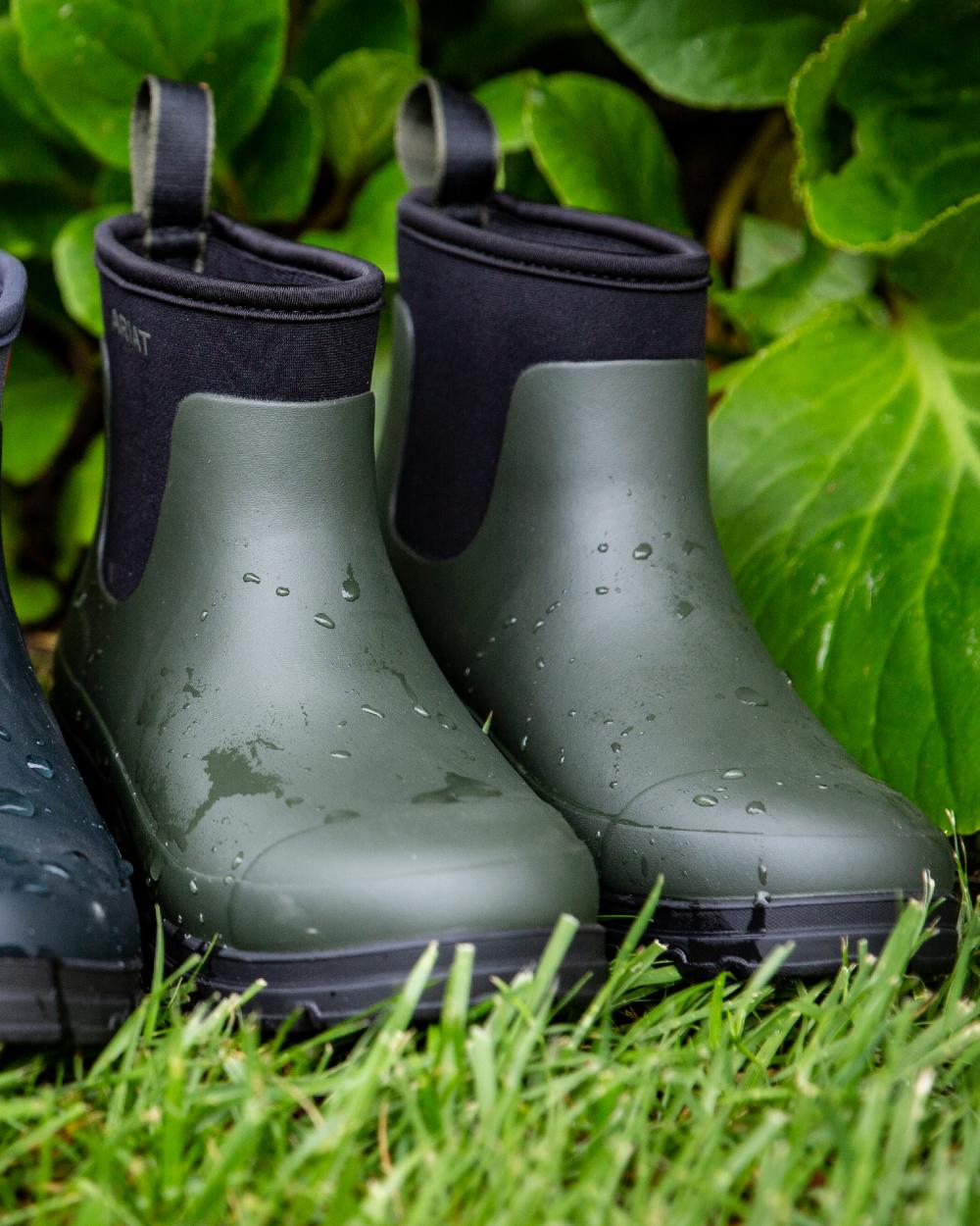 Dark Olive coloured Ariat Womens Kelmarsh Shortie Rubber Boots on grass background