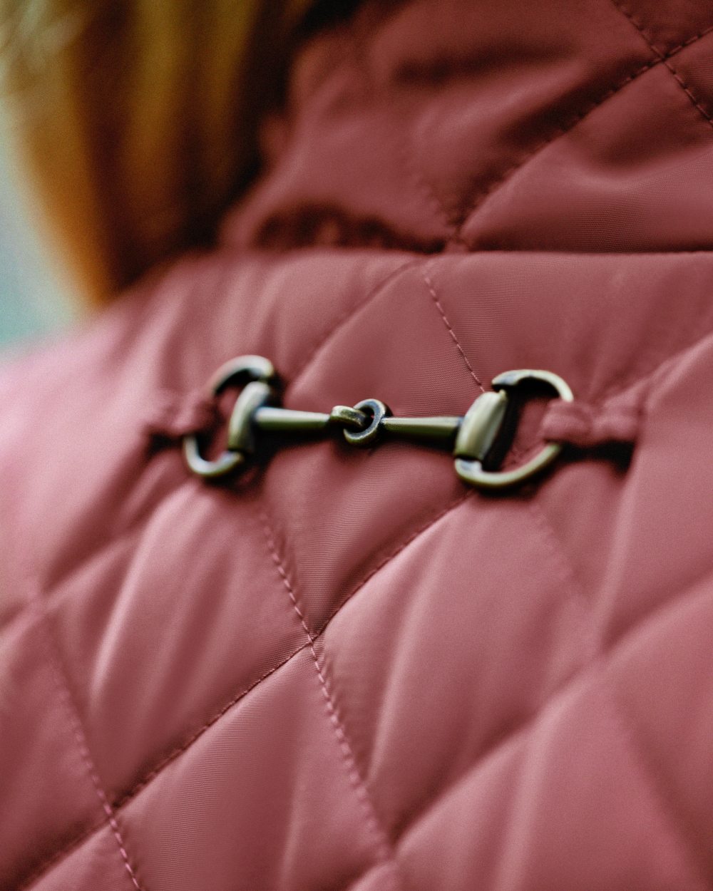 Marsala Coloured Ariat Womens Woodside Quilted Gilet on blurry background