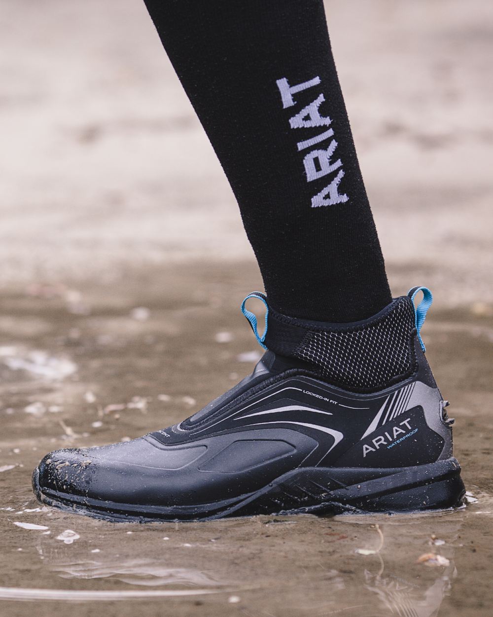 Black White coloured AriatTEK Performance Socks on ground background