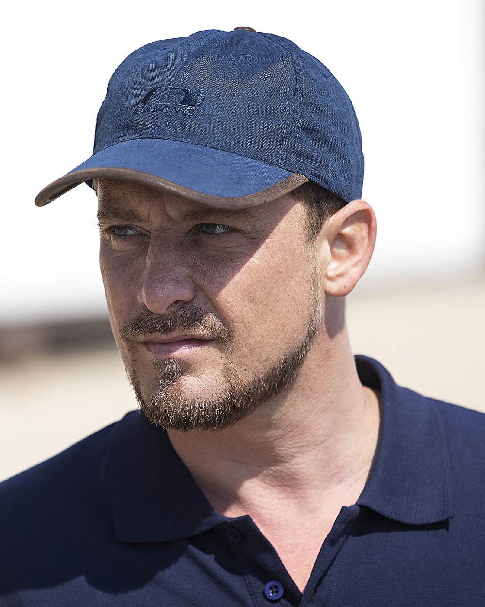 Navy Blue Coloured Baleno Ashford Cap on blurry background