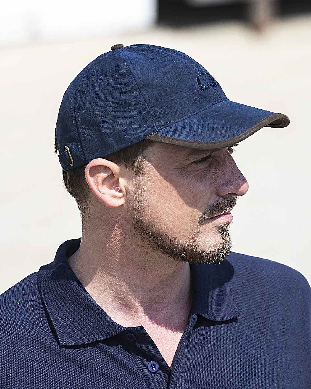 Navy Blue Coloured Baleno Ashford Cap on blurry background