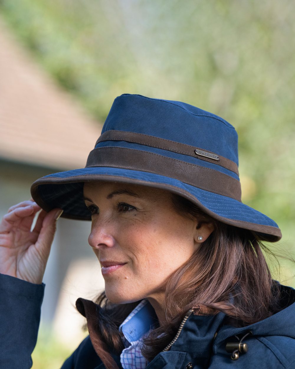 Navy Blue Coloured Baleno Edith Waterproof Hat on blurry background