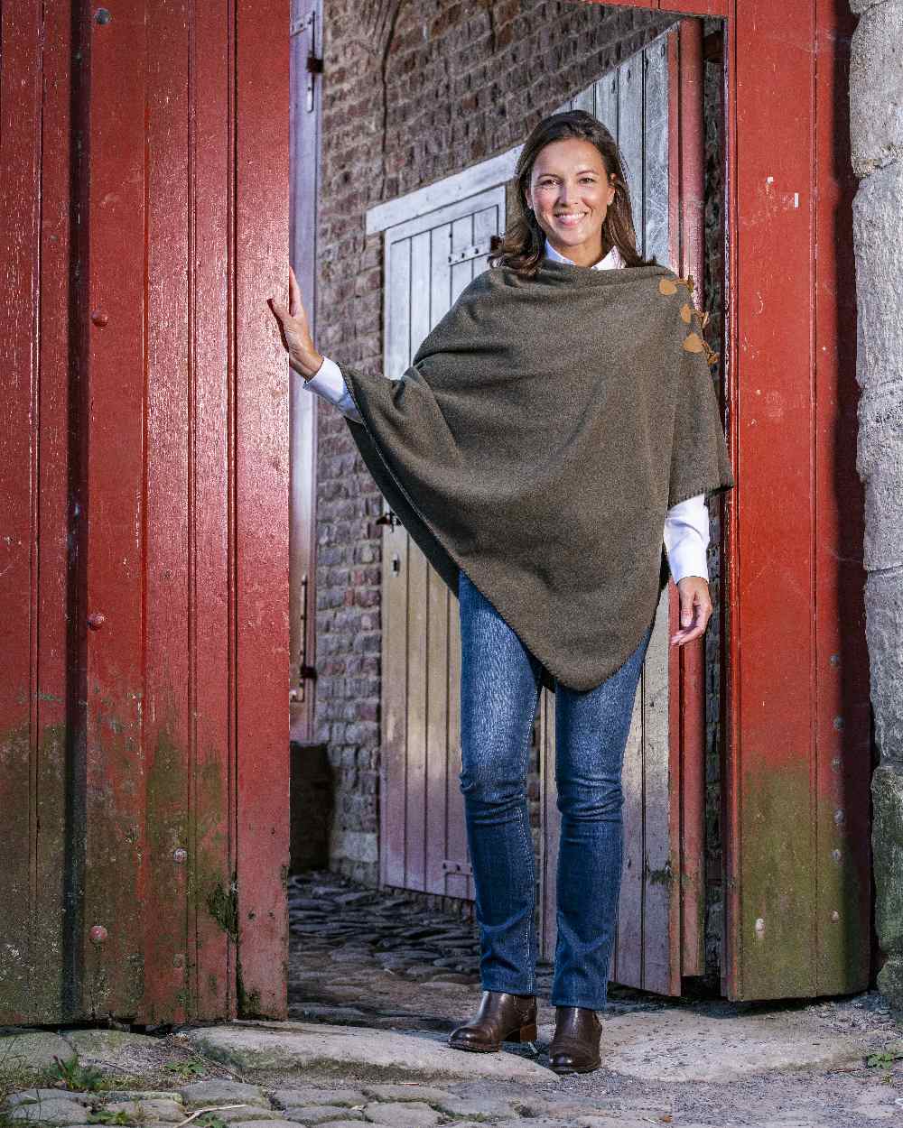 Moss Green Coloured Baleno Elite Fleece Poncho on door background