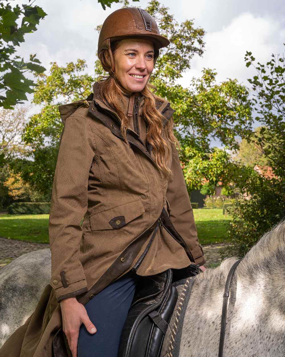 Camel Coloured Baleno Kensington Long Waterproof Coat on countryside background