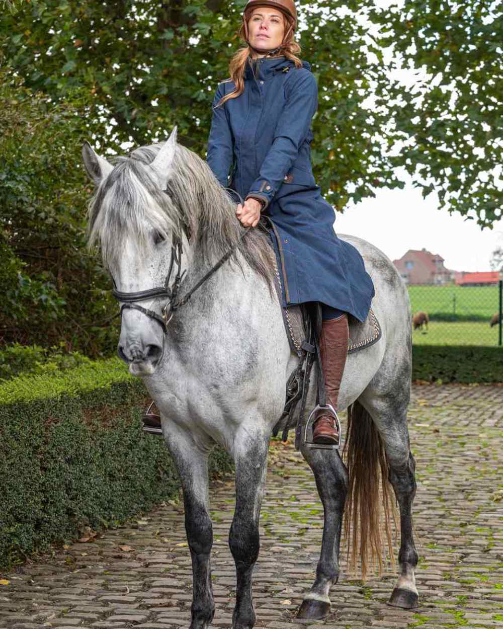 Navy Blue Coloured Baleno Kensington Long Waterproof Coat on countryside background