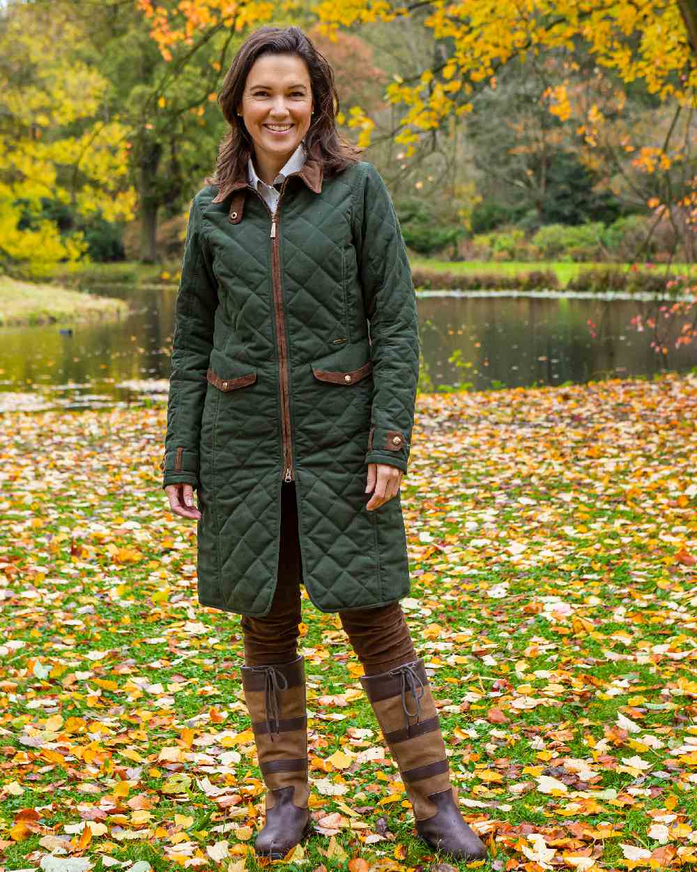 Dark Olive Green Coloured Baleno Womens Audrey Fashionable Quilted Ladies Coat on pond background