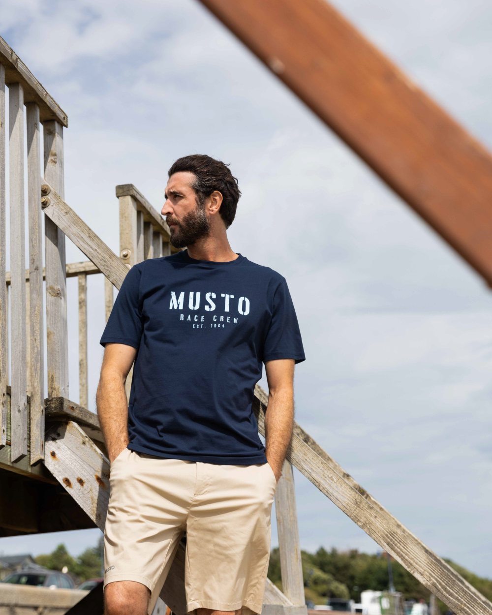 Beige Coloured Musto Mens RIB Fast Dry Shorts On A Coastal Background