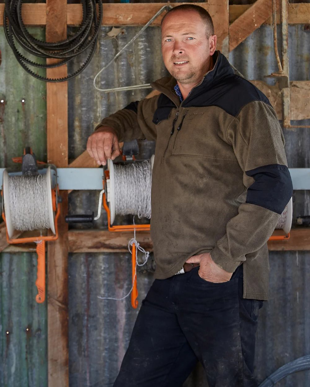 Olive coloured Betacraft Quest Eco Fleece Half Zip Top on factory background