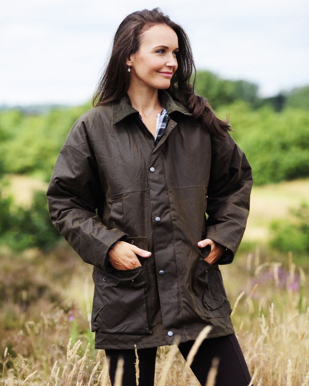 Green coloured Bronte Wax Cotton Jacket on grass background