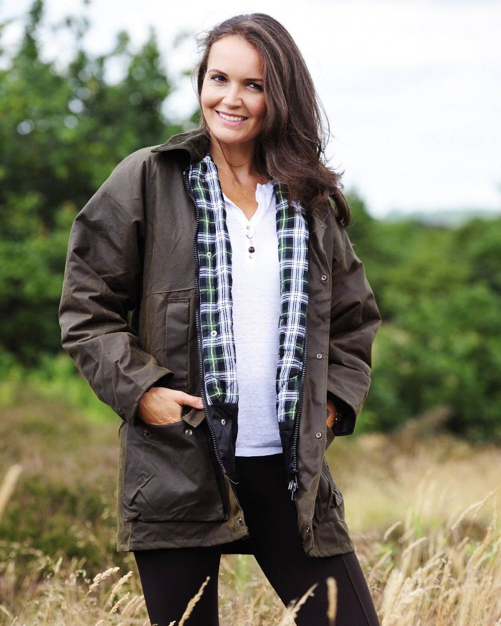 Green coloured Bronte Wax Cotton Jacket on grass background
