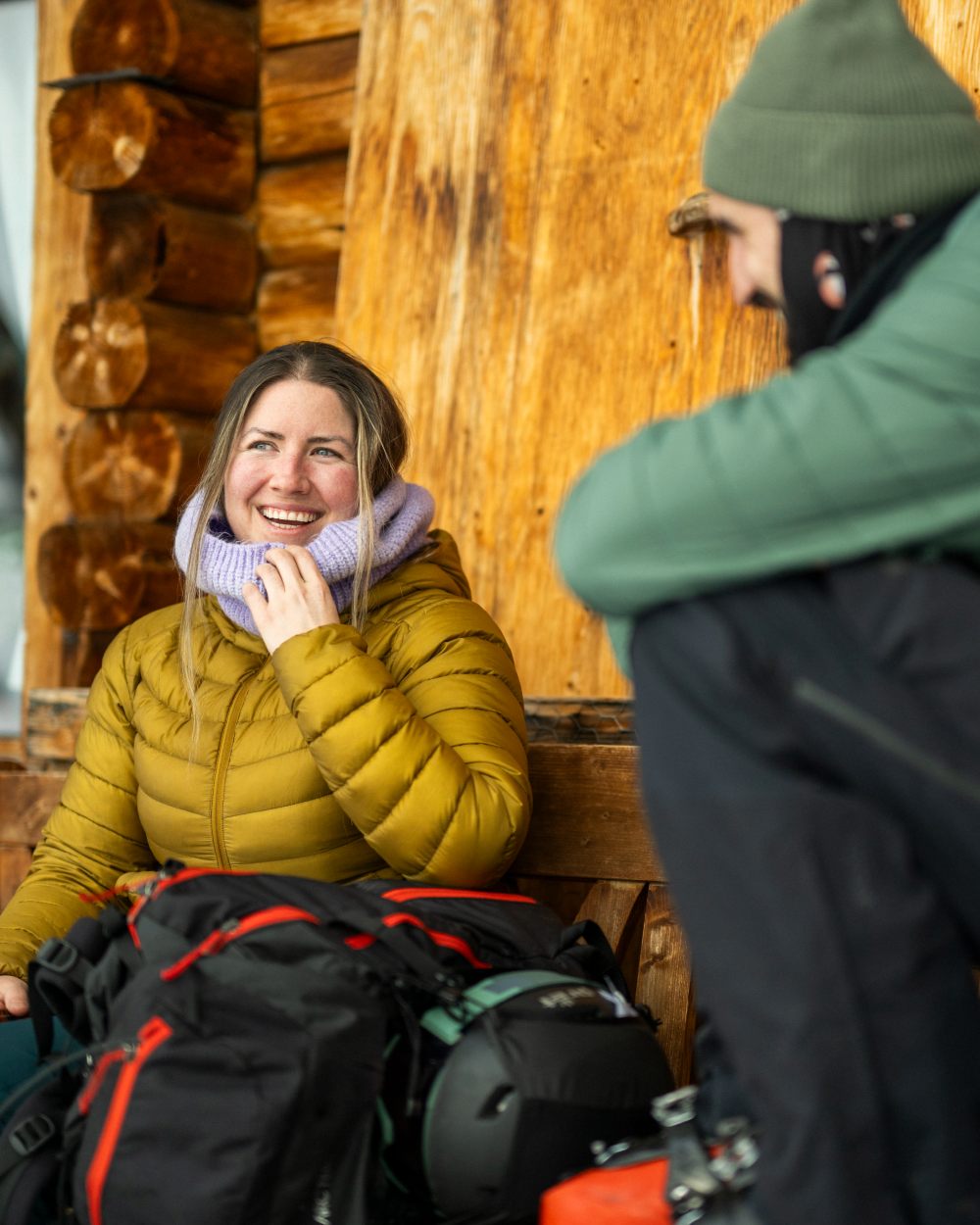 Lavender coloured Buff Datma Knitted Neckwarmer on Wooden Cabin background