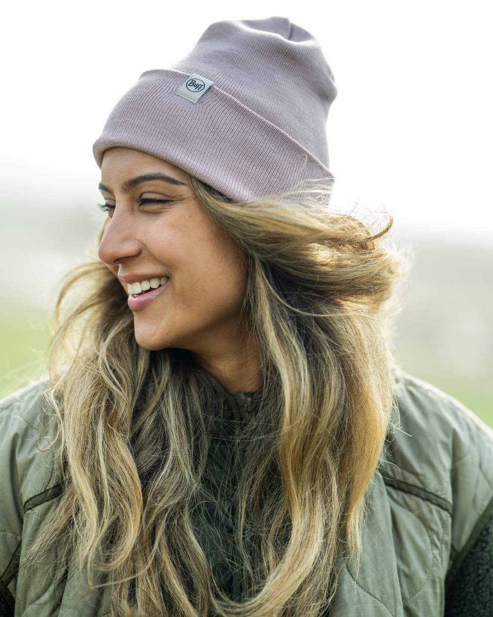 Rosewood Coloured Buff Linon Knitted Beanie on blurry background