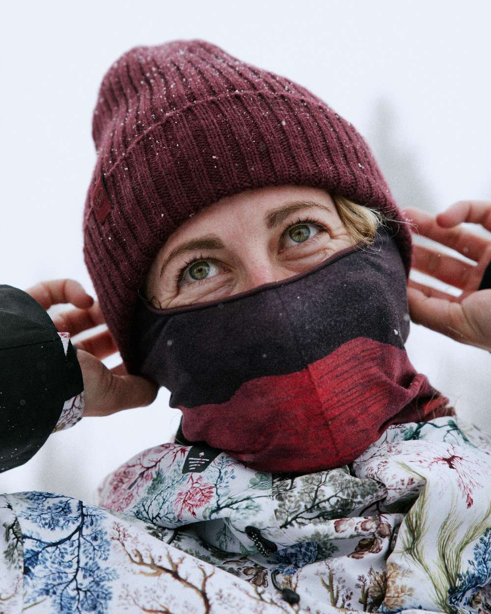 Maroon Coloured Buff Knitted Norval Beanie on snow background