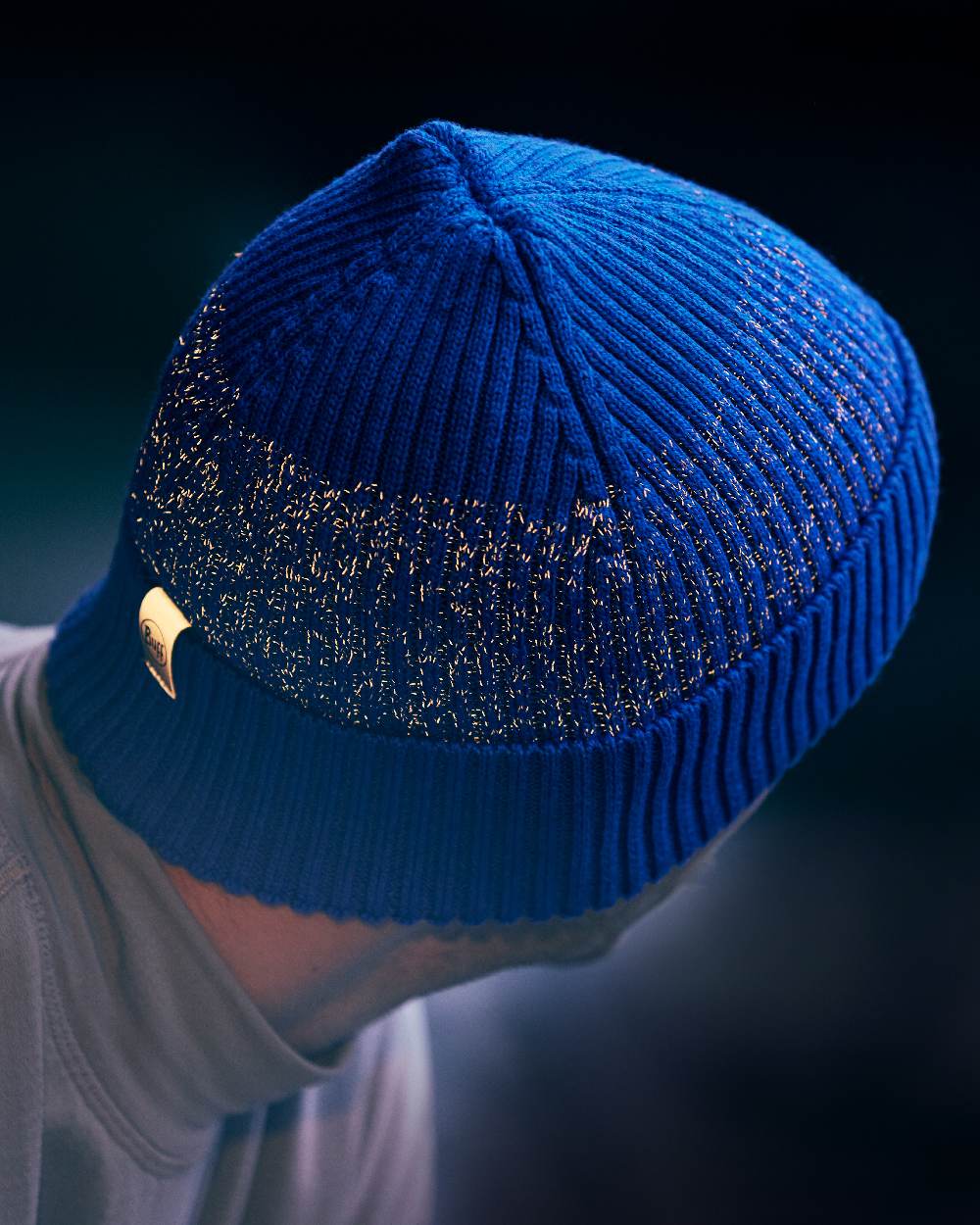 Cobalt Coloured Buff Merino Active Beanie on blurry background